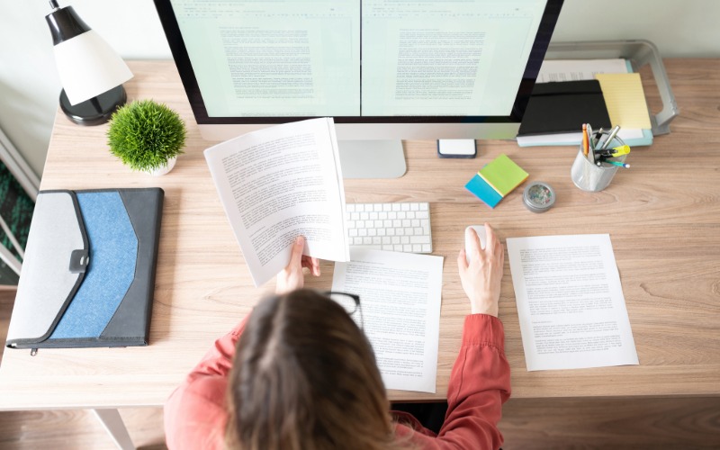 Traduttore davanti ad un laptop mentre traduce dei documenti